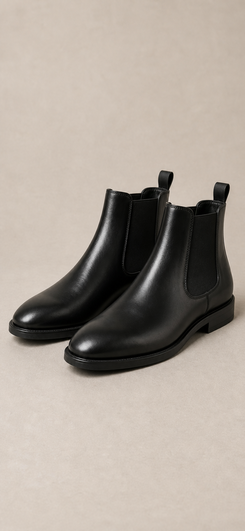Representative archive visual of black Chelsea boots.